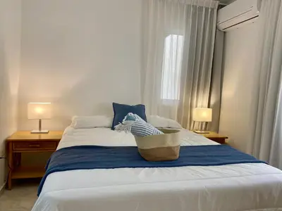a bedroom with a bed with a basket on it at Villas Princesa Beach Apartments in Punta Cana