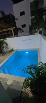 a large blue swimming pool in a building at Casa Madi in Bayahibe