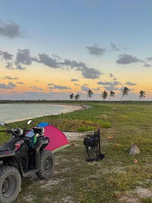 a quad bike with an umbrella and a chair at ATV Camping in Punta Cana in Punta Cana