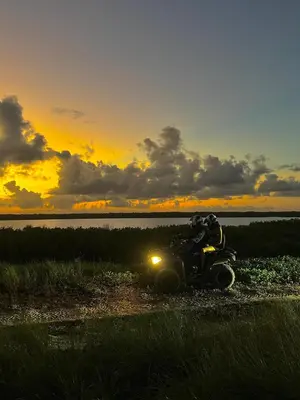 an atv parked on a dirt road at sunset at ATV Camping in Punta Cana in Punta Cana