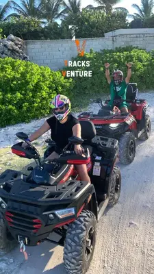 two people riding atvs on a dirt road at ATV Camping in Punta Cana in Punta Cana