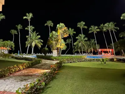 a park at night with palm trees and grass at Vista paraiso in La Puntica de Juan Dolio