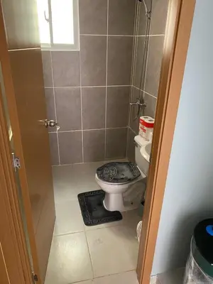 a small bathroom with a toilet in a shower at 1st floor 3 Bedrm 2 Baths AC Condo near airport in Los Paredones