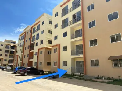 a car parked in front of a building with a blue arrow at 1st floor 3 Bedrm 2 Baths AC Condo near airport in Los Paredones