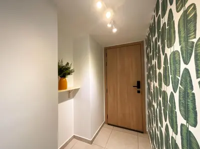 a hallway with a door with a green and white wall at Comfortable Central Apartment in Santo Domingo