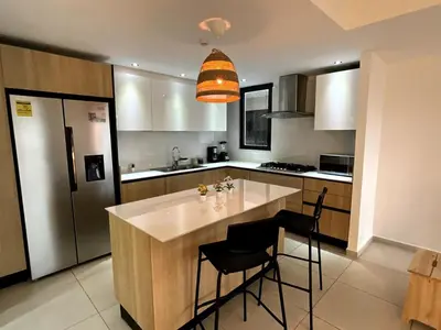 a kitchen with a large island in the middle at Comfortable Central Apartment in Santo Domingo