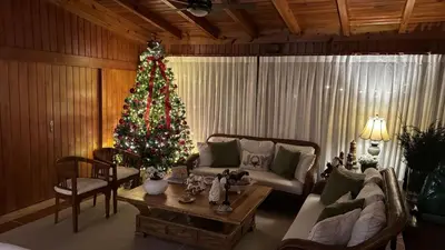 a living room with a christmas tree and a couch at Casa de Campo Tenis Villa 16 in La Romana