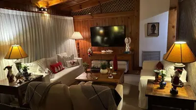 a living room with a couch and a tv at Casa de Campo Tenis Villa 16 in La Romana