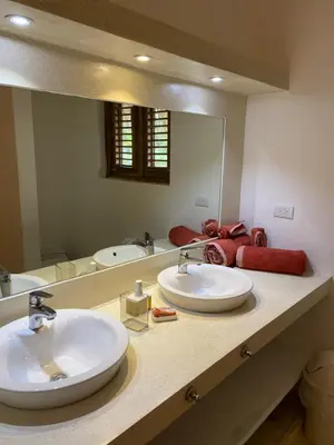 a bathroom with two sinks and a large mirror at Villa de Lima in Las Terrenas