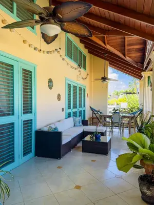 a living room with a couch and a ceiling fan at La Dolce Vita in Las Terrenas
