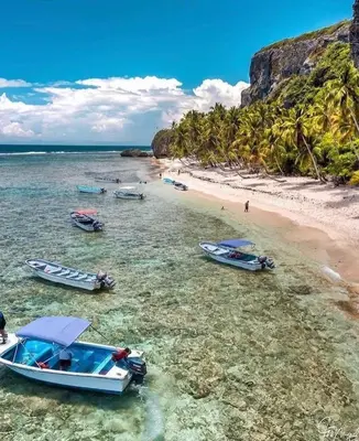 a group of boats in the water on a beach at Villa La Palmeras - 8 Pax, 5 min de La Playa in Las Galeras