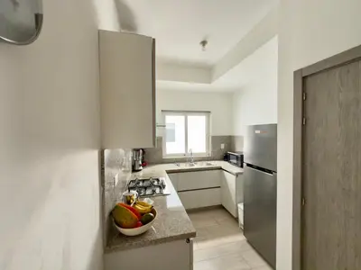 a kitchen with a bowl of fruit on the counter at Casa Mulata Paseo del Mar 2 Pool & Playa in Punta Cana