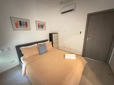 a bedroom with a large bed with two pillows at Casa Mulata Paseo del Mar 2 Pool & Playa in Punta Cana