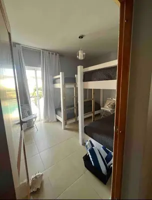 a bedroom with two bunk beds and a balcony at Cadaqués best sunset in La Fragata