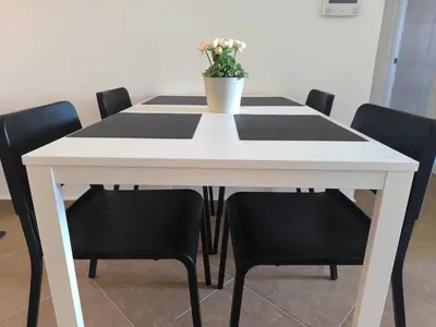 a white table with chairs and a potted plant on it at Cana Esmeralda in Punta Cana