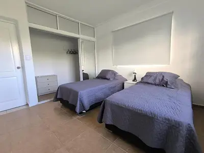 a bedroom with two beds with purple blankets at Cana Esmeralda in Punta Cana