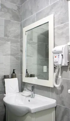 a bathroom with a sink and a mirror at Villa Rosa Boca Chica in Boca Chica