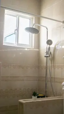 a shower with two lights in a bathroom at Villa Rosa Boca Chica in Boca Chica