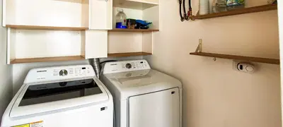 a washer and dryer in a small kitchen at AMAR'E beach front apartment overlooking pool in Las Terrenas
