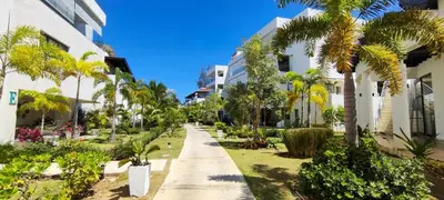 a sidewalk lined with palm trees next to a building at AMAR'E beach front apartment overlooking pool in Las Terrenas