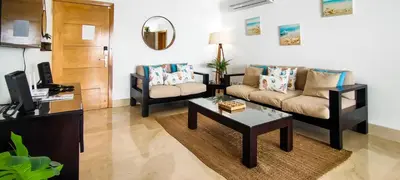 a living room with a couch and a coffee table at AMAR'E beach front apartment overlooking pool in Las Terrenas