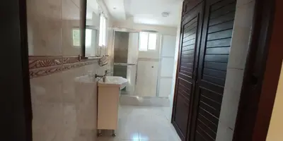 a bathroom with a sink and a toilet and a mirror at Essential Life La Cuaba Casa de Campo Amenities in Pedro Brand