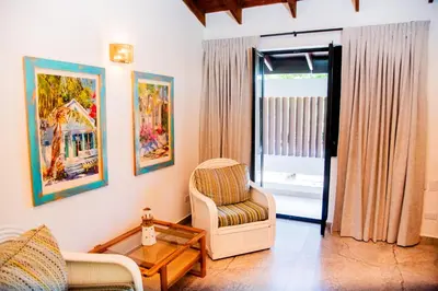 a living room with a chair and a table at Central Hotel Boutique in Las Galeras