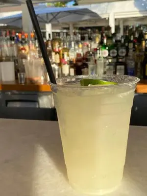 a drink with a lime on a table in a bar at Villa Allegria Los Lagos 57 in La Romana