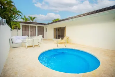 a large blue swimming pool on a patio at Villa Allegria Los Lagos 57 in La Romana