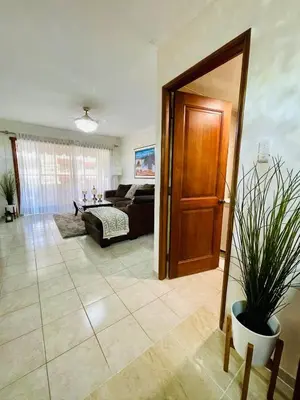 a living room with a couch and a table at FreshBreeze - Apartment Near US Embassy in Santo Domingo