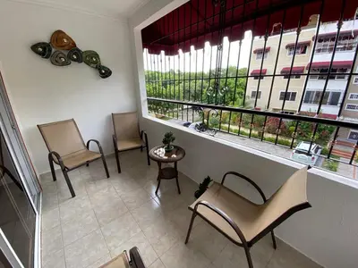 a waiting room with three chairs and a large window at FreshBreeze - Apartment Near US Embassy in Santo Domingo
