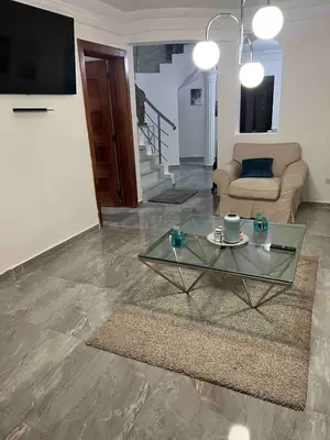 a living room with a glass table and a couch at Villa Gordon in Santa Cruz de Barahona