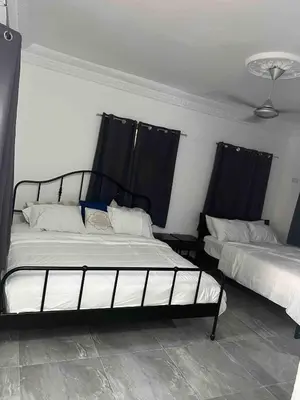two beds in a room with black drapes at Villa Gordon in Santa Cruz de Barahona
