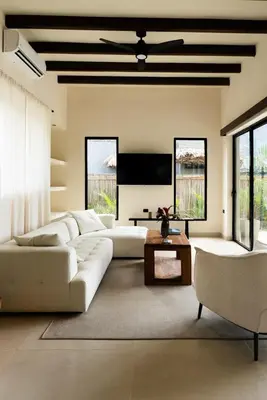 a living room with a white couch and a tv at Casa Sharon in El Valle