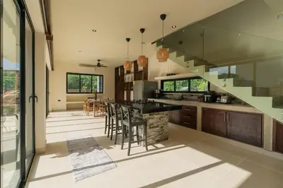 a large kitchen with a staircase and a table at Casa Sharon in El Valle