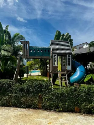 a playground with a house and a slide at 3BR & Rooftop Jacuzzi Near Beach in Las Terrenas