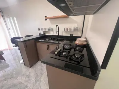 a kitchen with a stove and a counter top at cerca de los mejores restaurantes I TV l Wifi in Constanza