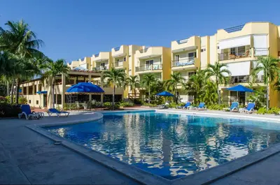 a swimming pool in front of a resort at Garden Condo, Sosua in Sosúa