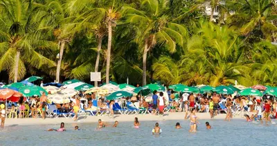 a crowd of people on a beach with umbrellas at Hannabi in Colorado