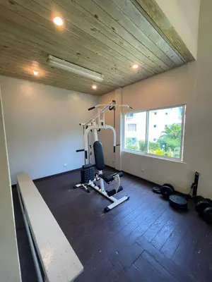 a room with a gym with a treadmill and a simulator at Luxury apartment Playa Dorada in Puerto Plata