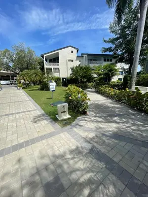 a building with a sign in the middle of a sidewalk at Luxury apartment Playa Dorada in Puerto Plata