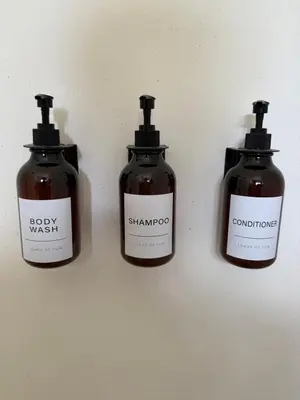 a group of three bottles of soap on a wall at Kaia Beach Lodge en Cosón in Las Terrenas