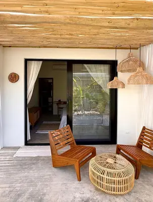 a patio with two chairs and a table at Kaia Beach Lodge en Cosón in Las Terrenas