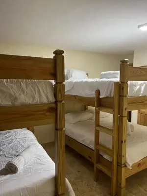 two wooden bunk beds in a room withthritisthritisthritisthritisccess at Villa para grupos in Concepción de La Vega
