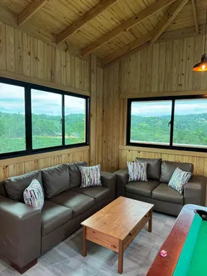 a living room with a couch and a table at Villa para grupos in Concepción de La Vega