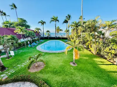 an aerial view of a yard with a swimming pool and palm trees at Las Terrenas La Dolce Vita 7, Captivating and Exciting in Las Terrenas