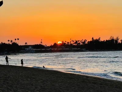 two people walking on the beach at sunset at Las Terrenas La Dolce Vita 7, Captivating and Exciting in Las Terrenas