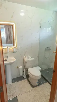 a bathroom with a toilet and a sink and a shower at Agua Azul Boca Chica Accommodation in Andrés