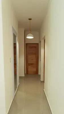 a hallway with a wooden door in a house at Agua Azul Boca Chica Accommodation in Andrés