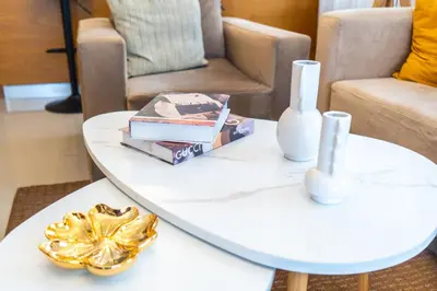 a white coffee table with books and a vase on it at Apartment in Santo Domingo in Santo Domingo